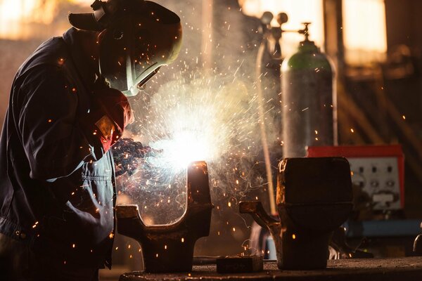 A working welder in a protective mask