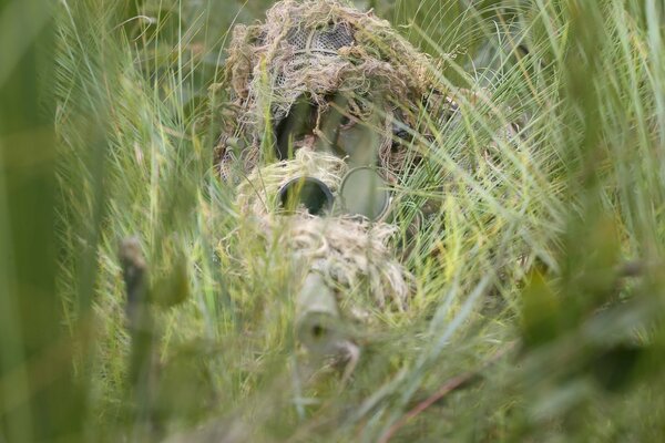 A soldier in camouflage with a gun