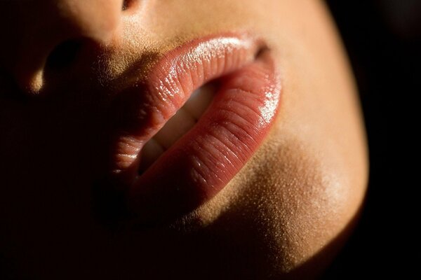 Alluring, slightly parted lips of a girl close-up