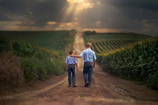 Son and father walking through agricultural fields