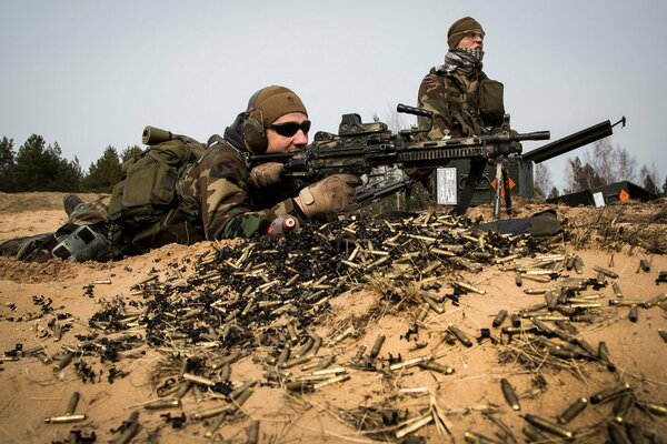 Latvian special forces with weapons in the desert