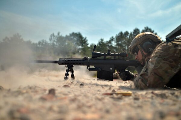 A soldier with a sniper rifle holds at gunpoint