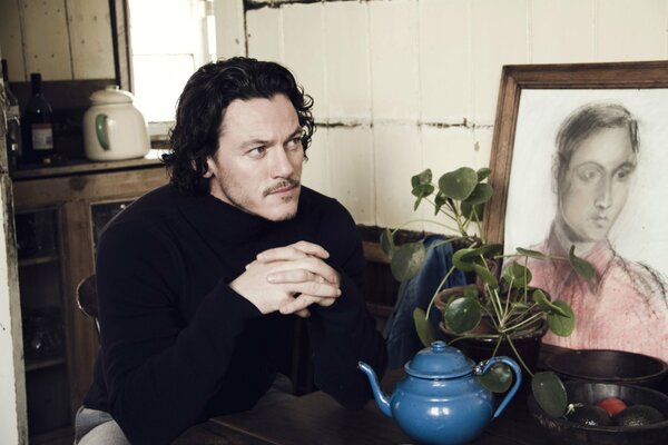 Luke Evans admires the portrait