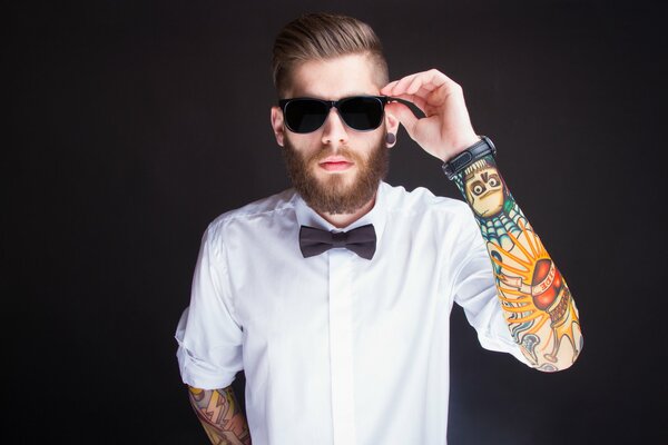 A man with tattoos on a black background