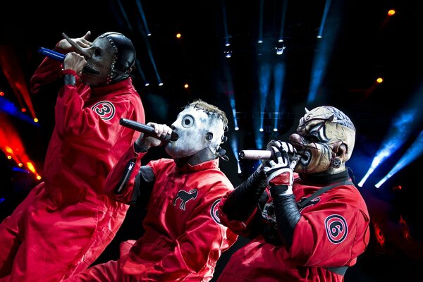 Sean Crahon, Corey Taylor, Chris Feng in red suits perform their songs