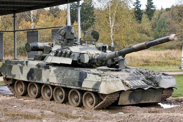 A military tank makes its way through the mud