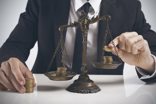 A man puts coins on the scales