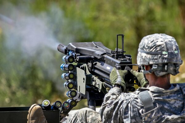 An armed soldier with grenade launchers in his hands