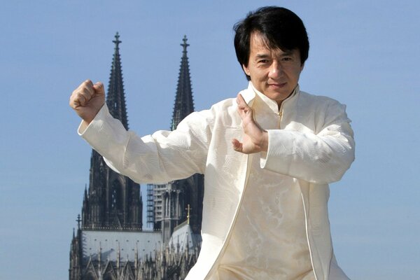Jackie Chan in a white suit in a kung fu stand