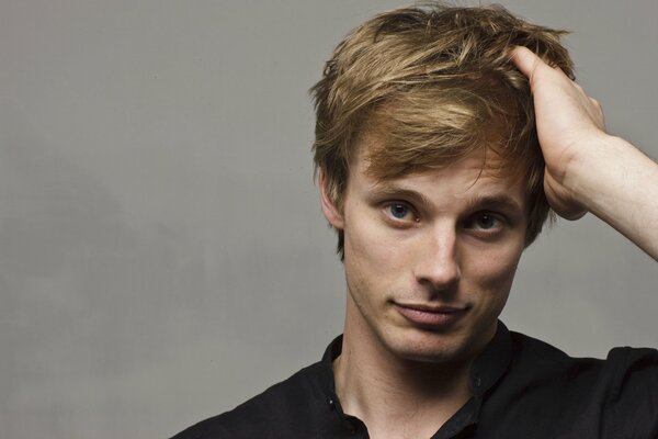 A cute portrait of Bradley James on a neutral background