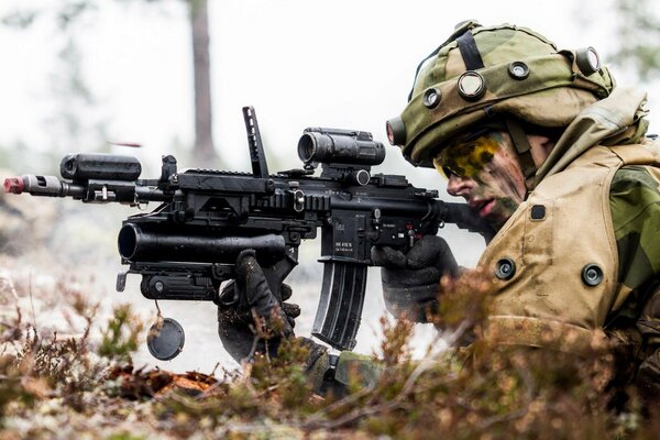 A soldier lying on the ground with a weapon