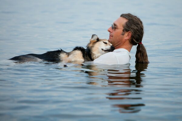 A man and a dog in calm water