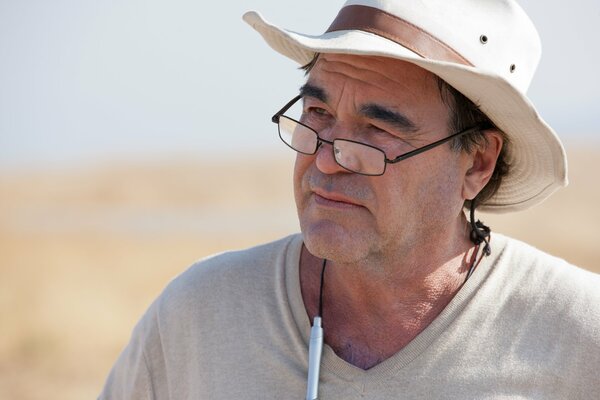 Director Oliver Stone in a hat