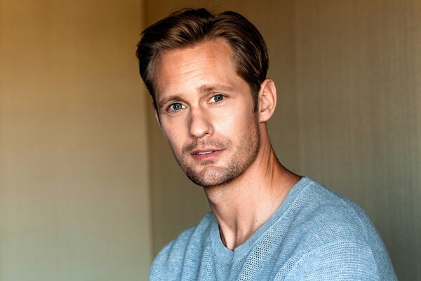 Alexander Skarsgard in a blue sweater