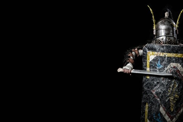 Knight in armor and with a shield on a black background