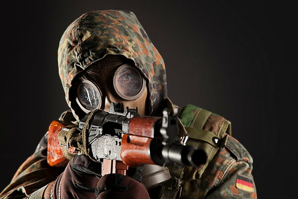 A male soldier in a gas mask with a weapon