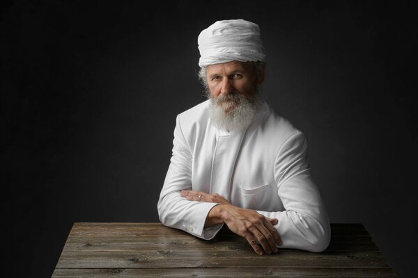 A gray-bearded grandfather in a white robe