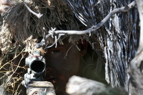 A soldier holds a weapon in the army