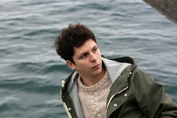 Actor Michael Cera on the background of water