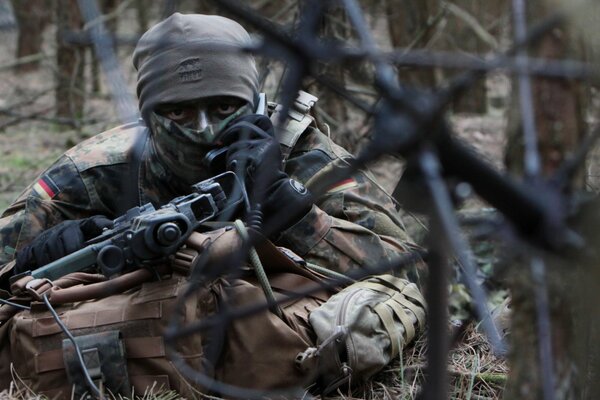 A soldier in the army with a gun. Combat exercises