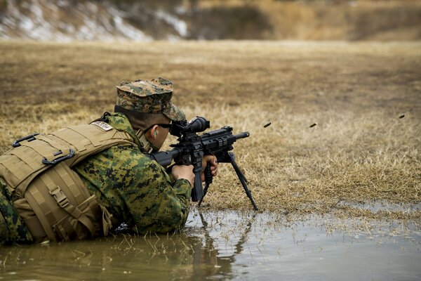 Un soldado de la infantería de Marina de los Estados Unidos dispara disparos con un rifle automático m27