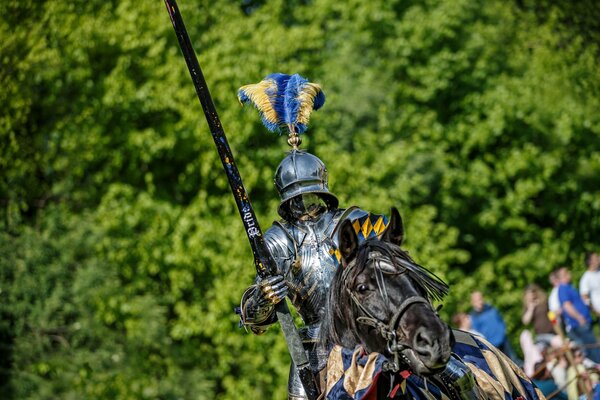 A knight in armor rides a horse