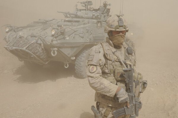 A soldier in full combat readiness in the desert