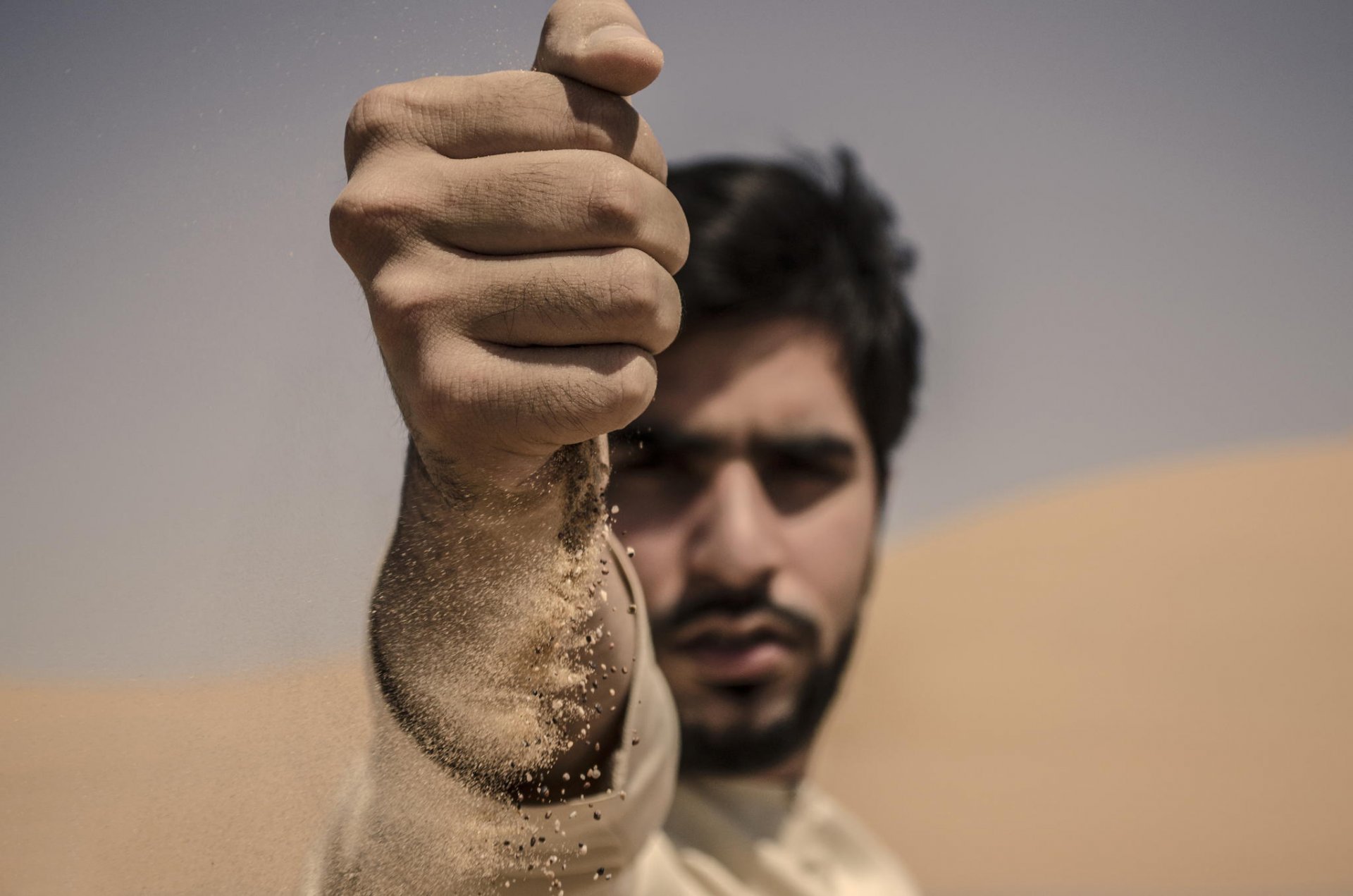 close up hand sand portrait