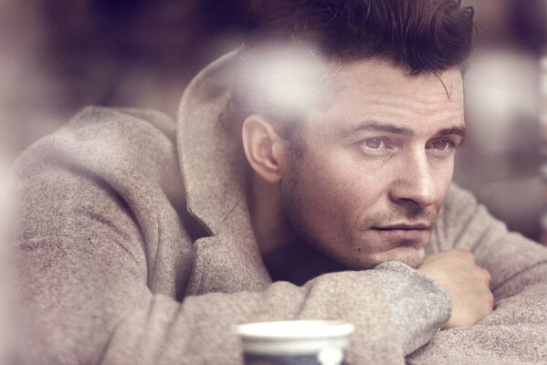 Portrait of Orlando Bloom in a gray coat