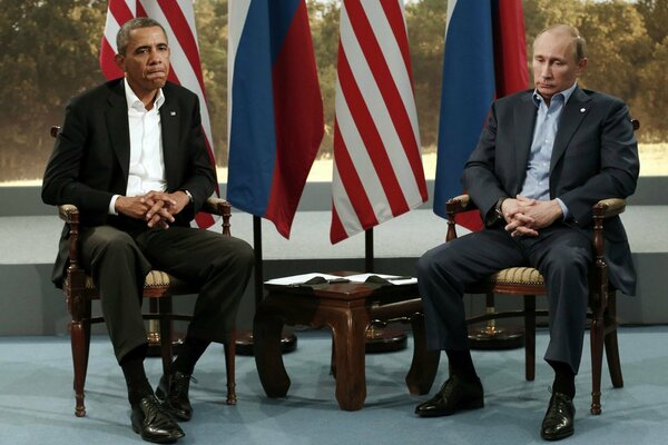 Sad Barack Obama and Vladimir Vladimirovich Putin sit in silence at the meeting