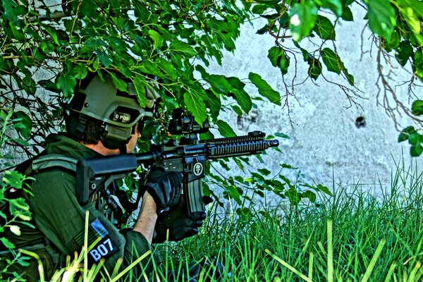 A male soldier hid behind a tree