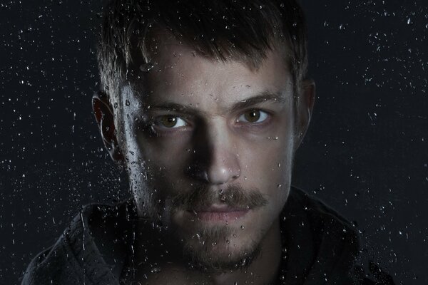 Portrait of Kinnaman in raindrops in the night