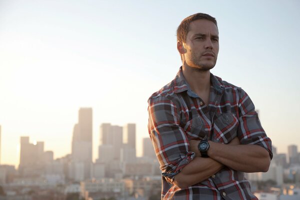 Portrait of Taylor in a plaid shirt against the background of the city