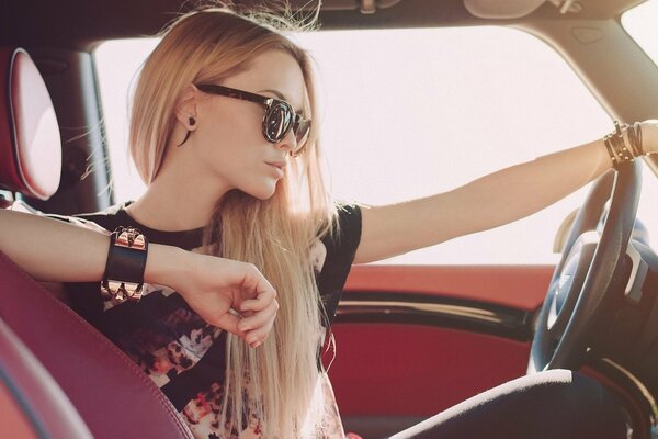 Beautiful blonde in a car with long hair