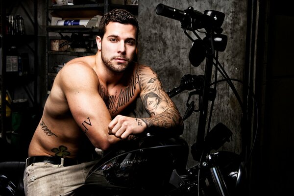 Young guy on a motorcycle with tattoos