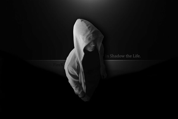 A man in a hood with the inscription in the shadow of life