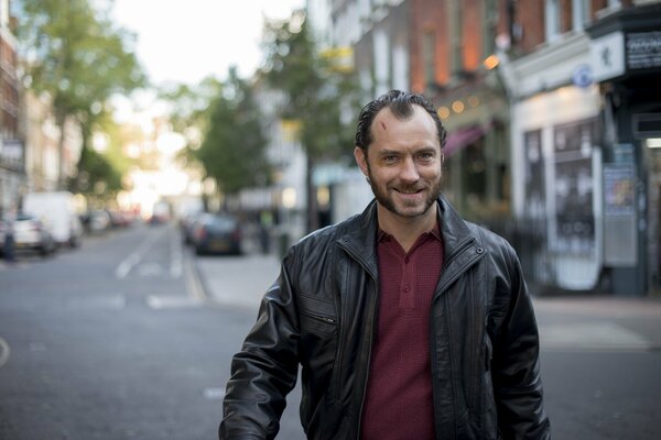 A handsome man walks smiling