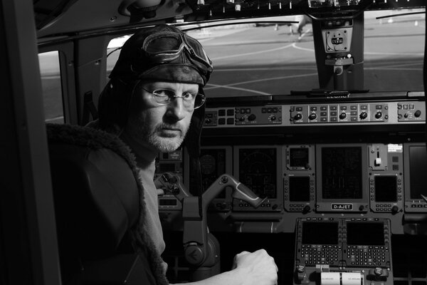 Black and white photo of Dmitry Puchkov at the controls of an airplane