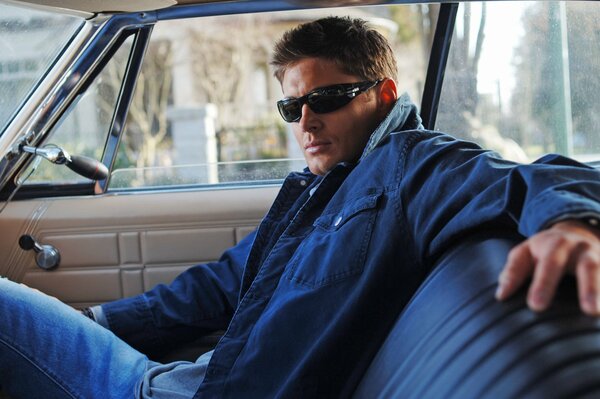 Jensen Ackles wearing glasses in the car