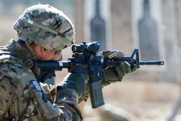 War and a soldier with a gun shoots