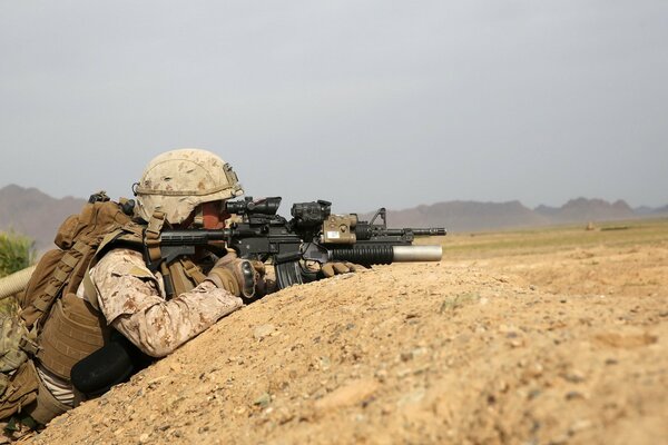 A soldier in a trench is waiting for the enemy