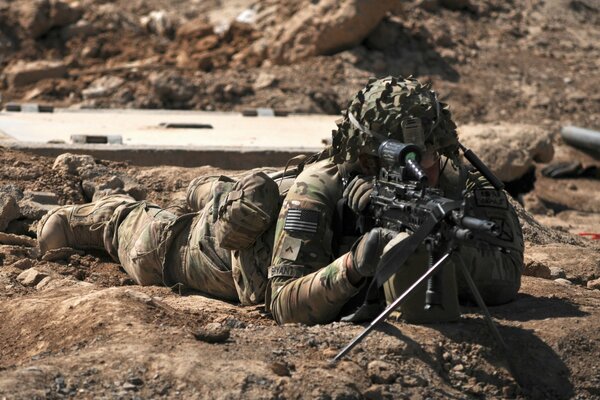 Soldier sniper aims at the target