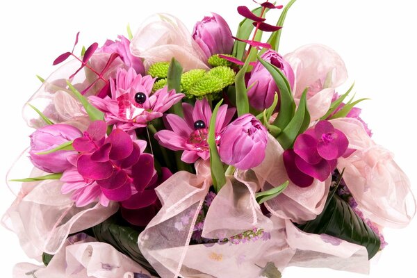 Flowers with tulips tied in a ribbon