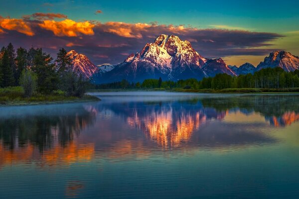 A landscape of unprecedented beauty with the reflection of a mountain on a river