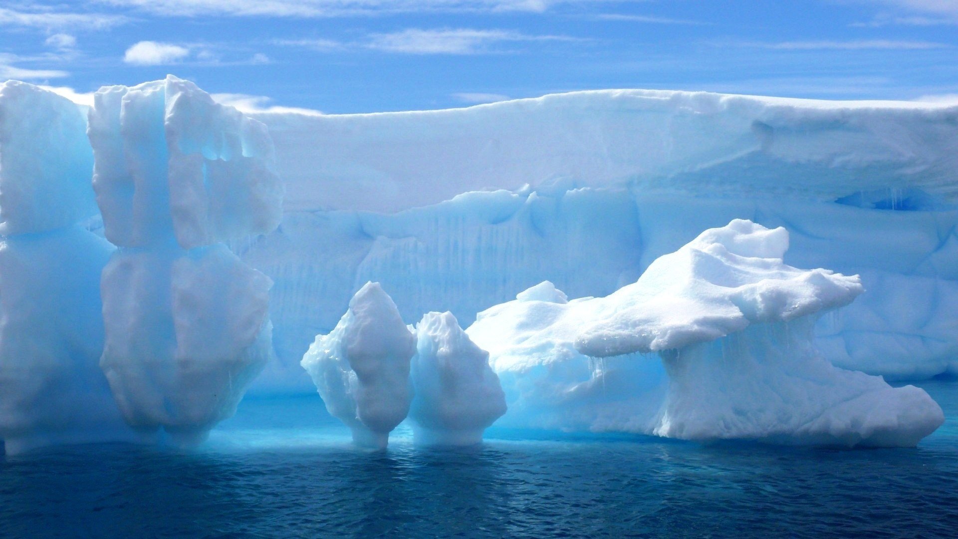 iceberg snow the ocean blue the sky