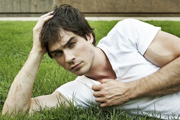 Ian Somerhalder is resting on the grass