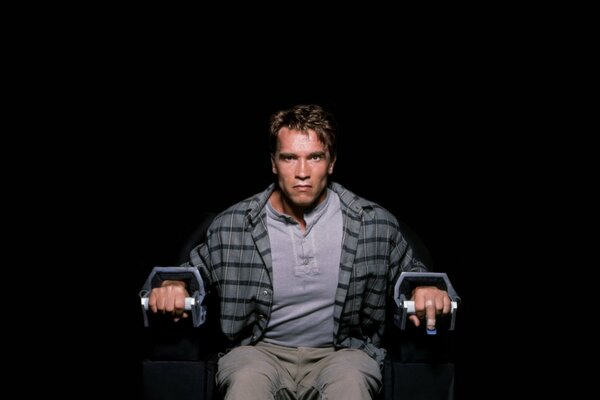 The evil Arnold Schwarzenegger is chained to a chair