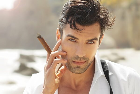 The guy with blue eyes with a cigar