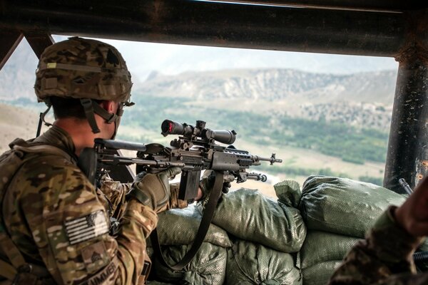 An American soldier in a car with a rifle