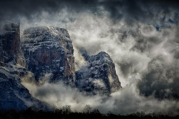 High mountains in fog and clouds at night